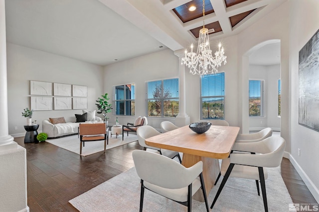 dining area with coffered ceiling, a high ceiling, dark wood-type flooring, beam ceiling, and an inviting chandelier