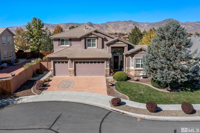 view of front of property with a mountain view and a garage