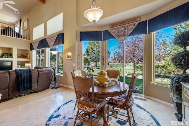 tiled dining space featuring ceiling fan