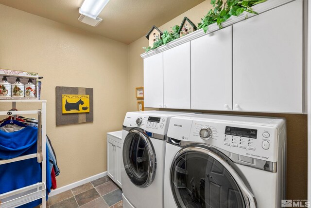 washroom with independent washer and dryer and cabinets