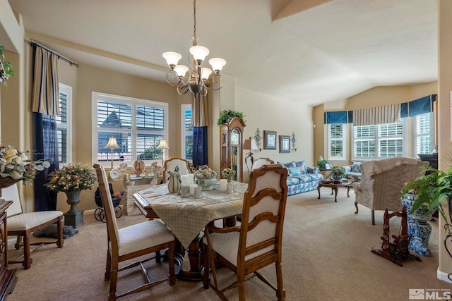 carpeted dining space with lofted ceiling and a notable chandelier