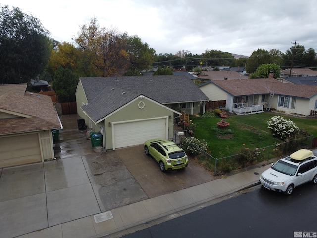 view of front of home with a garage and a front lawn