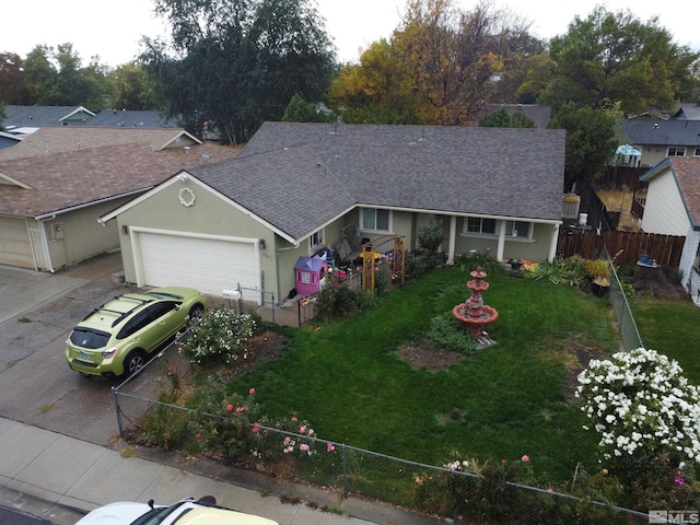 ranch-style home featuring a garage and a front lawn