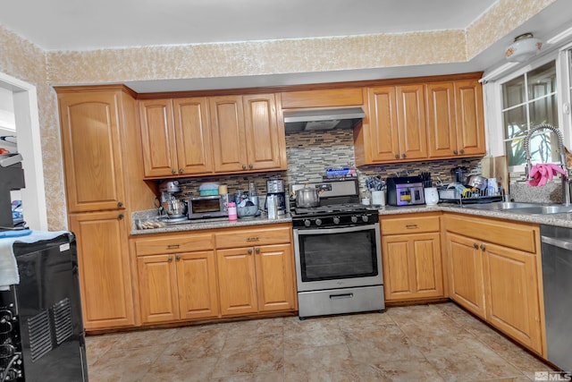 kitchen with backsplash, sink, stainless steel appliances, and extractor fan