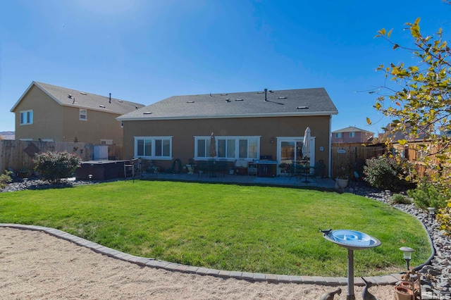 back of house featuring a patio area and a yard