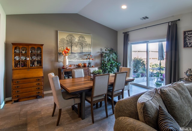 dining area featuring vaulted ceiling