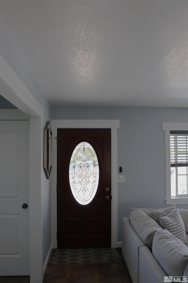 foyer entrance featuring a textured ceiling