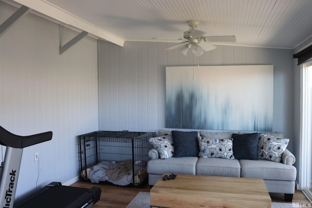 living room with wooden walls, vaulted ceiling, dark hardwood / wood-style floors, and ceiling fan