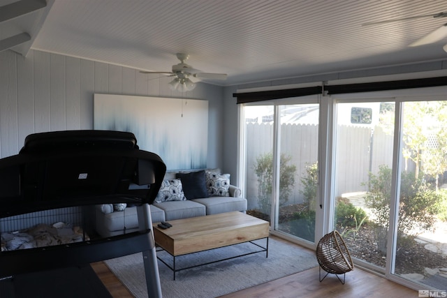 sunroom / solarium featuring ceiling fan