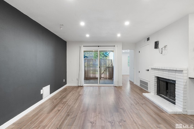 unfurnished living room with light hardwood / wood-style floors and a fireplace