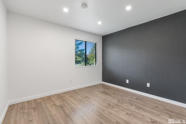 spare room featuring light hardwood / wood-style floors