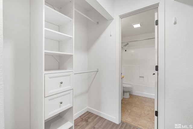 spacious closet featuring light hardwood / wood-style flooring