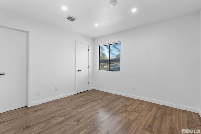 unfurnished room with hardwood / wood-style floors