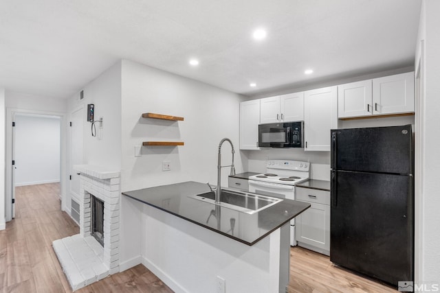 kitchen featuring light hardwood / wood-style floors, kitchen peninsula, white cabinetry, and black appliances