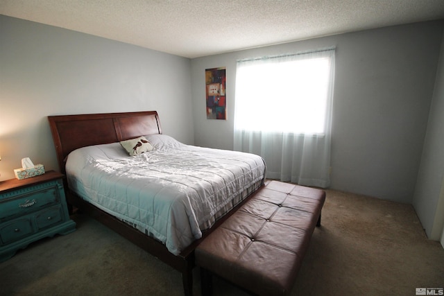 carpeted bedroom featuring a textured ceiling