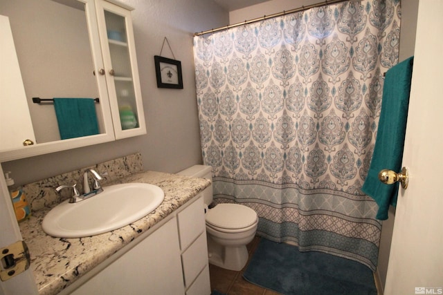 bathroom with vanity, toilet, walk in shower, and tile patterned flooring