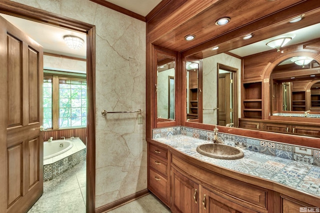 bathroom featuring vanity, crown molding, tile patterned floors, and a washtub