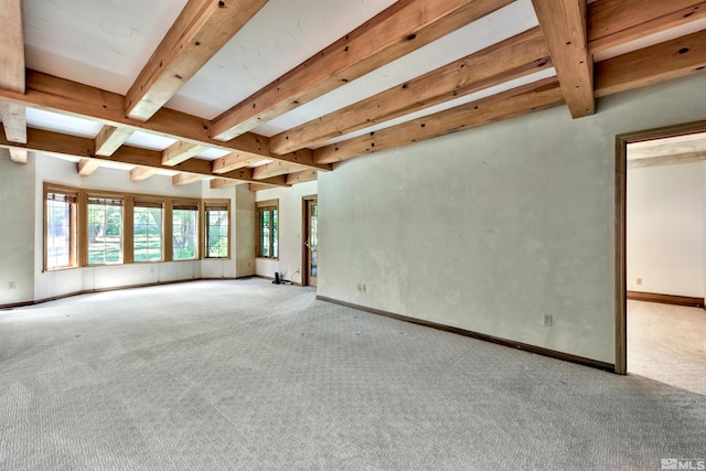 unfurnished living room featuring beam ceiling and light colored carpet