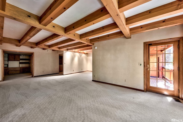 unfurnished living room featuring beam ceiling and light colored carpet