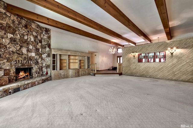 unfurnished living room featuring wood walls, carpet flooring, and a stone fireplace