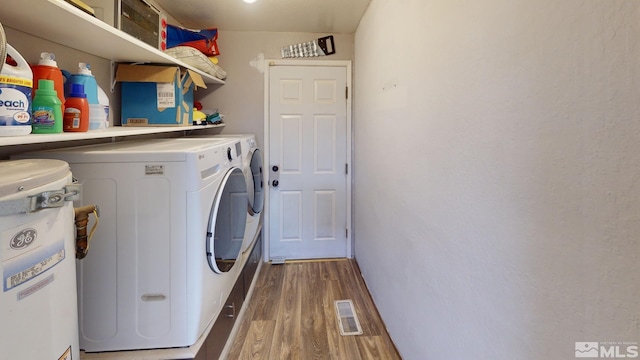 washroom featuring washer and dryer and hardwood / wood-style flooring