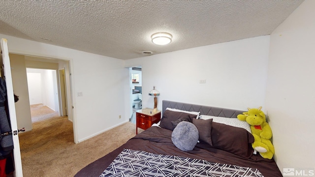 carpeted bedroom with a textured ceiling