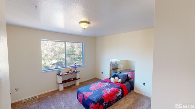 bedroom with a textured ceiling and carpet