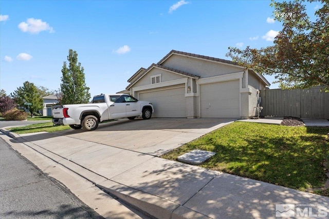 view of side of home featuring a garage and a yard