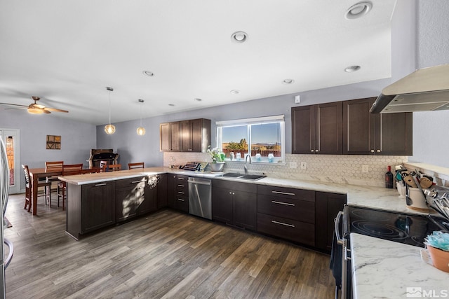 kitchen with kitchen peninsula, ventilation hood, sink, dishwasher, and hanging light fixtures