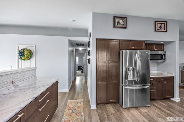 kitchen featuring decorative backsplash, hardwood / wood-style floors, and stainless steel appliances