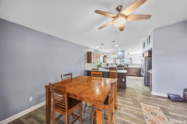 dining room featuring light hardwood / wood-style floors and ceiling fan