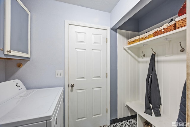 washroom featuring washing machine and clothes dryer and cabinets