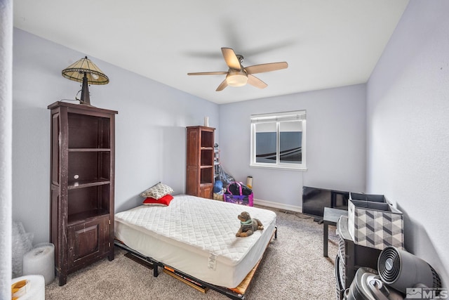 bedroom featuring light carpet and ceiling fan