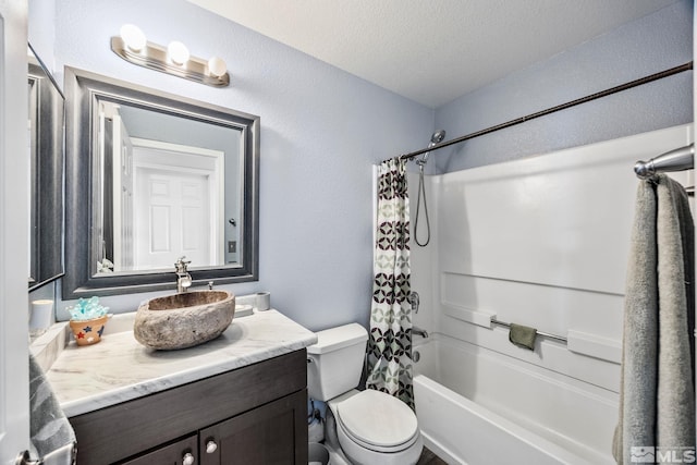 full bathroom featuring shower / bath combination with curtain, toilet, a textured ceiling, and vanity