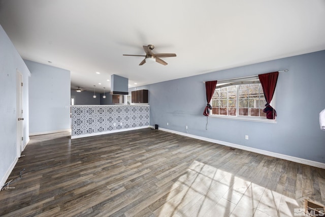 unfurnished living room with ceiling fan and wood-type flooring