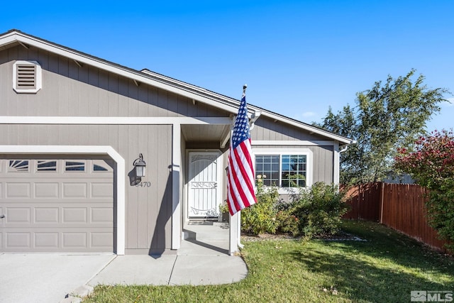 ranch-style home with a garage and a front lawn