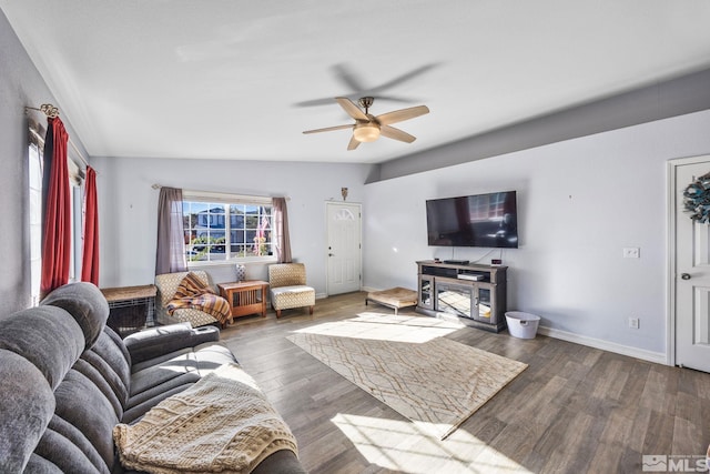 living room featuring lofted ceiling, ceiling fan, and dark wood-type flooring