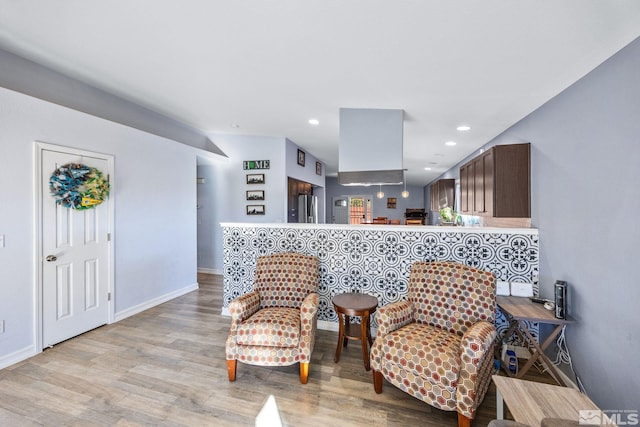 sitting room featuring light hardwood / wood-style flooring