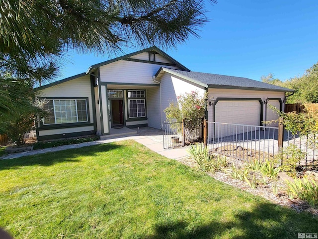 view of front of property with a front yard and a garage