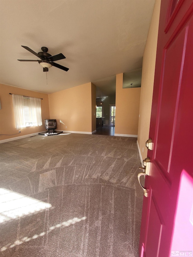 interior space with ceiling fan and carpet floors