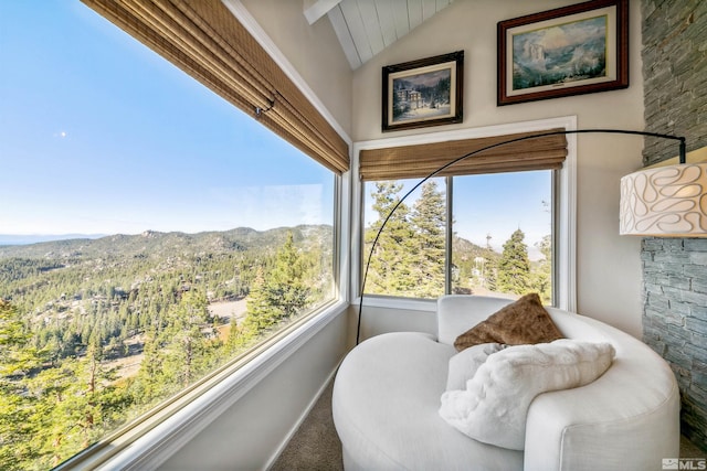 sunroom featuring a mountain view and lofted ceiling