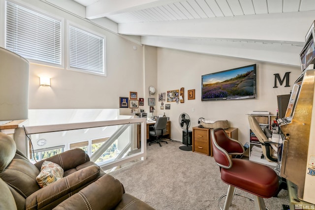 carpeted office featuring lofted ceiling with beams