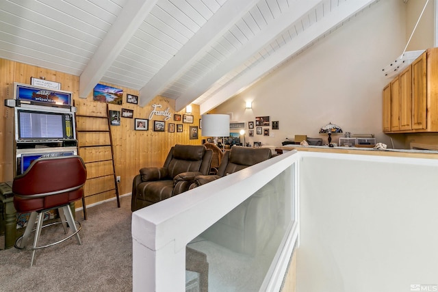 living room featuring vaulted ceiling with beams, wood walls, and light colored carpet