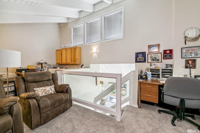 office area with lofted ceiling with beams and light colored carpet