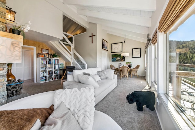 carpeted living room featuring beam ceiling and high vaulted ceiling