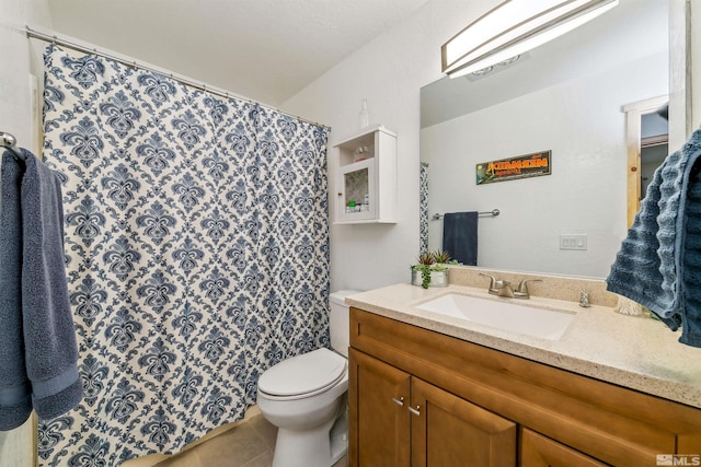 bathroom featuring toilet, vanity, and tile patterned floors