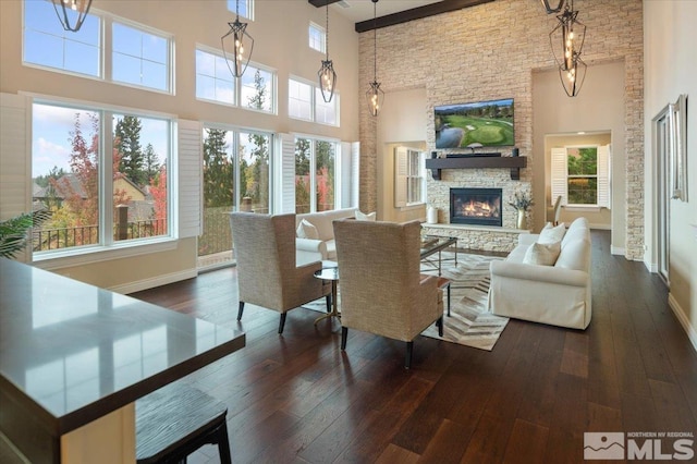 sunroom with plenty of natural light and a fireplace