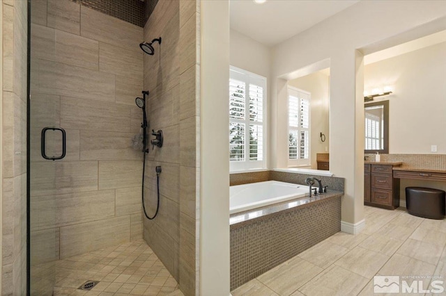 bathroom featuring vanity, plus walk in shower, and tile patterned floors