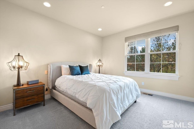 bedroom featuring a notable chandelier and carpet flooring