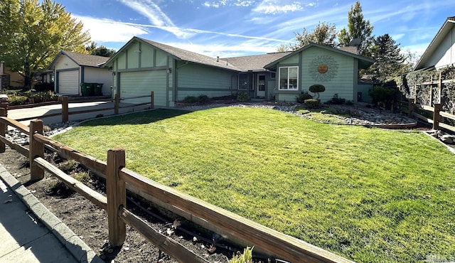 ranch-style house featuring a front yard and a garage